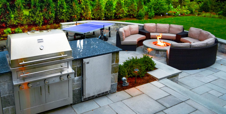 bluestone patio backyard with grill island and fire pit